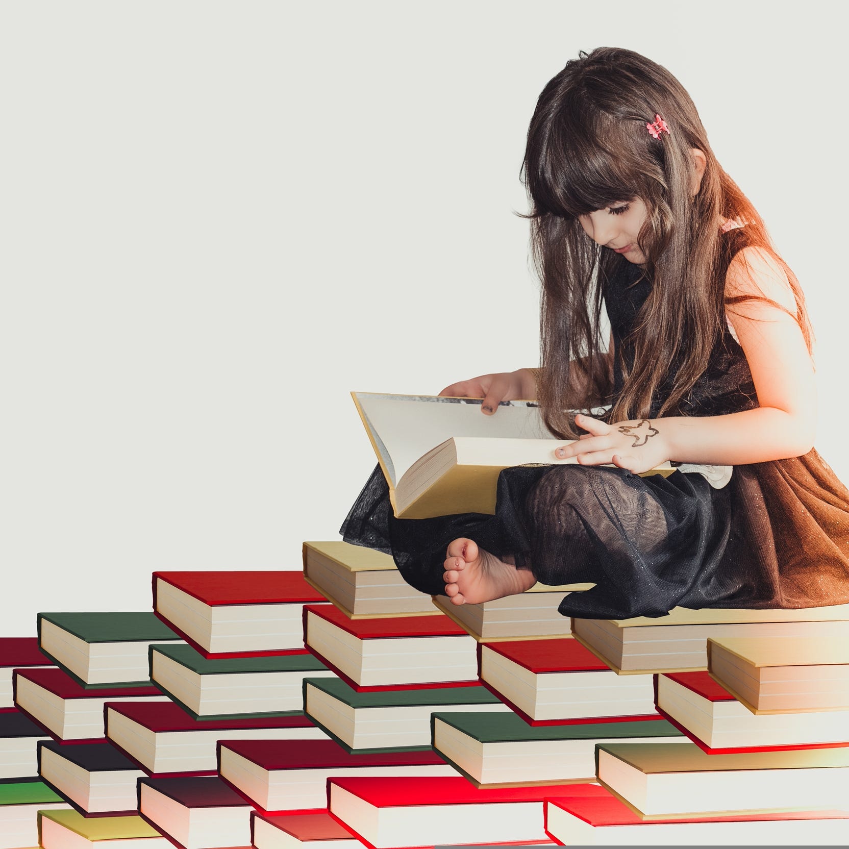 girl on pile of books