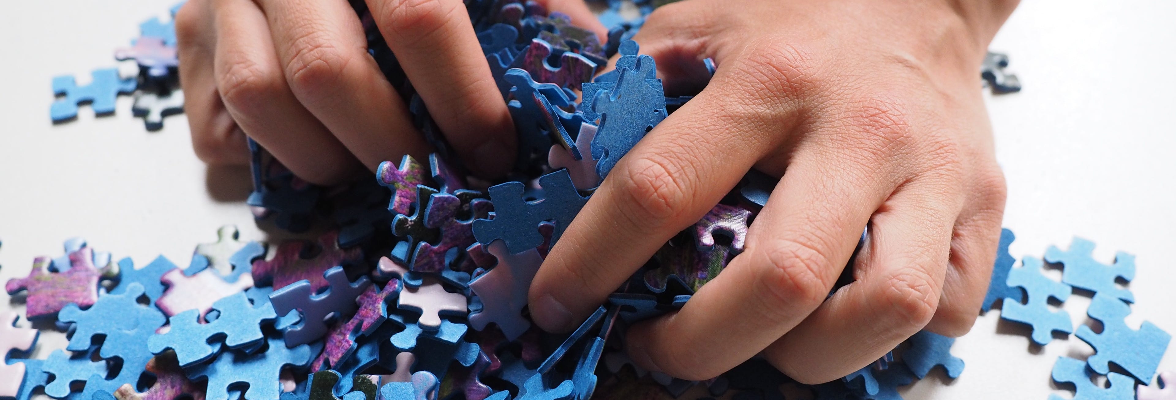 Hands holding puzzle pieces